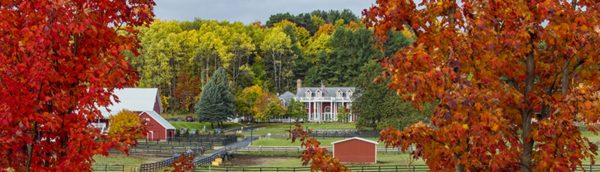 Inn with horse paddocks in the fall.