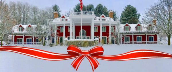 The Inn with snow and a festive bow.