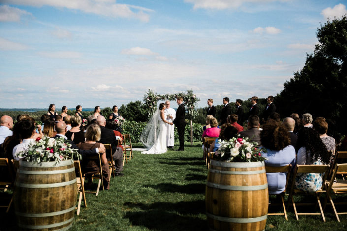 Wedding ceremony with guests at our scenic hilltop vineyard site.