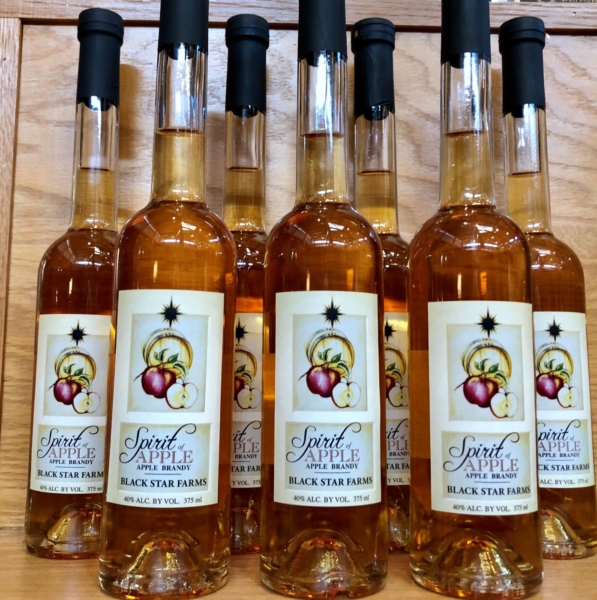 Many bottles of Black Star Farms Apple Brandy displayed in our Suttons Bay tasting room.