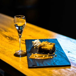 A glass of Sirius Maple Dessert Wine with Apple Upside-Down Spice Cake.