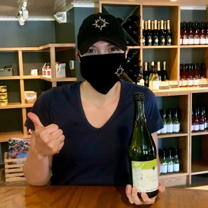 Tasting room manager wearing a face mask.