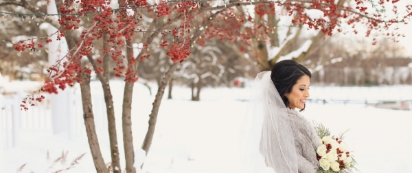 Bride with bouquet in winter scene.