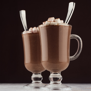 Two mugs of hot chocolate with marshmallows.