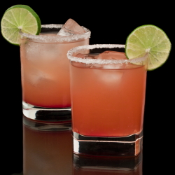 Two salty dog cocktails with lime garnish.
