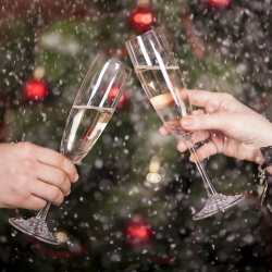 People toasting sparkling wine with a festive background.