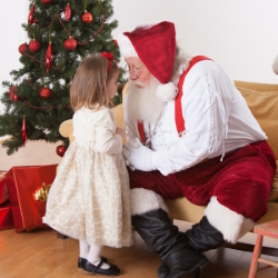 Santa talking to a little girl.