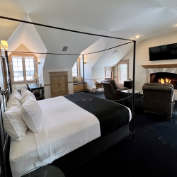 Diadem suite with king bed, sitting area, and fireplace.